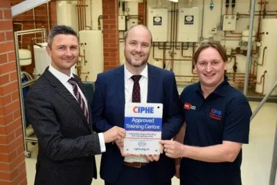 Presenting the award, Paul Halmer CIPHE, with Nick Fothergill, training manager at Worcester and Paul Williams, president of CIPHE Presenting the award, Paul Halmer CIPHE, with Nick Fothergill, training manager at Worcester and Paul Williams, president of CIPHE