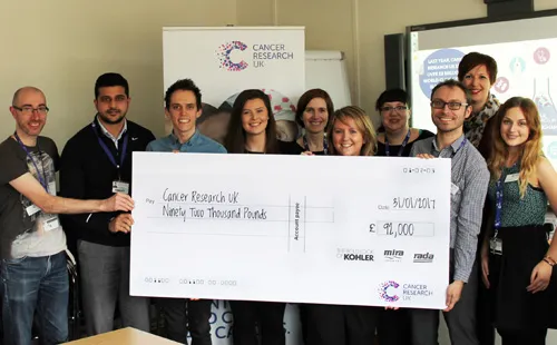 Sarah Sadler, Kohler Mira Finance Director hands a cheque of £92,000 over to the CRUK fundraising team. Sarah Sadler, Kohler Mira Finance Director hands a cheque of £92,000 over to the CRUK fundraising team.