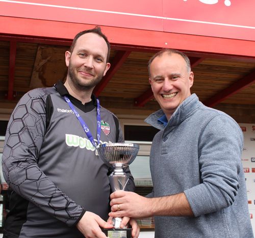 Mira marketing director, Craig, Baker hands over the trophy to the fun day 11-a-side winning team – from Mira marketing.