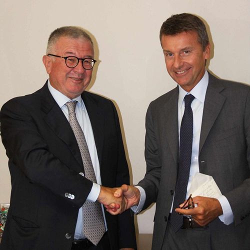 Alberto Cristina (left) and Marco Caleffi (right) shake hands on the acquisition of Cristina by Caleffi