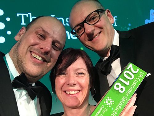 David Roberts (right), celebrates winning the ICS Customer Feedback Strategy Award with the company’s head of operations, Steve Nixon (left), and HR manager, Nikki Terry (centre)