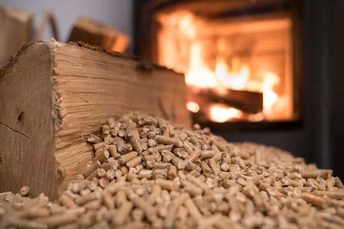 Wood,Stove,Heating,With,In,Foreground,Wood,Pellets,-,Economical